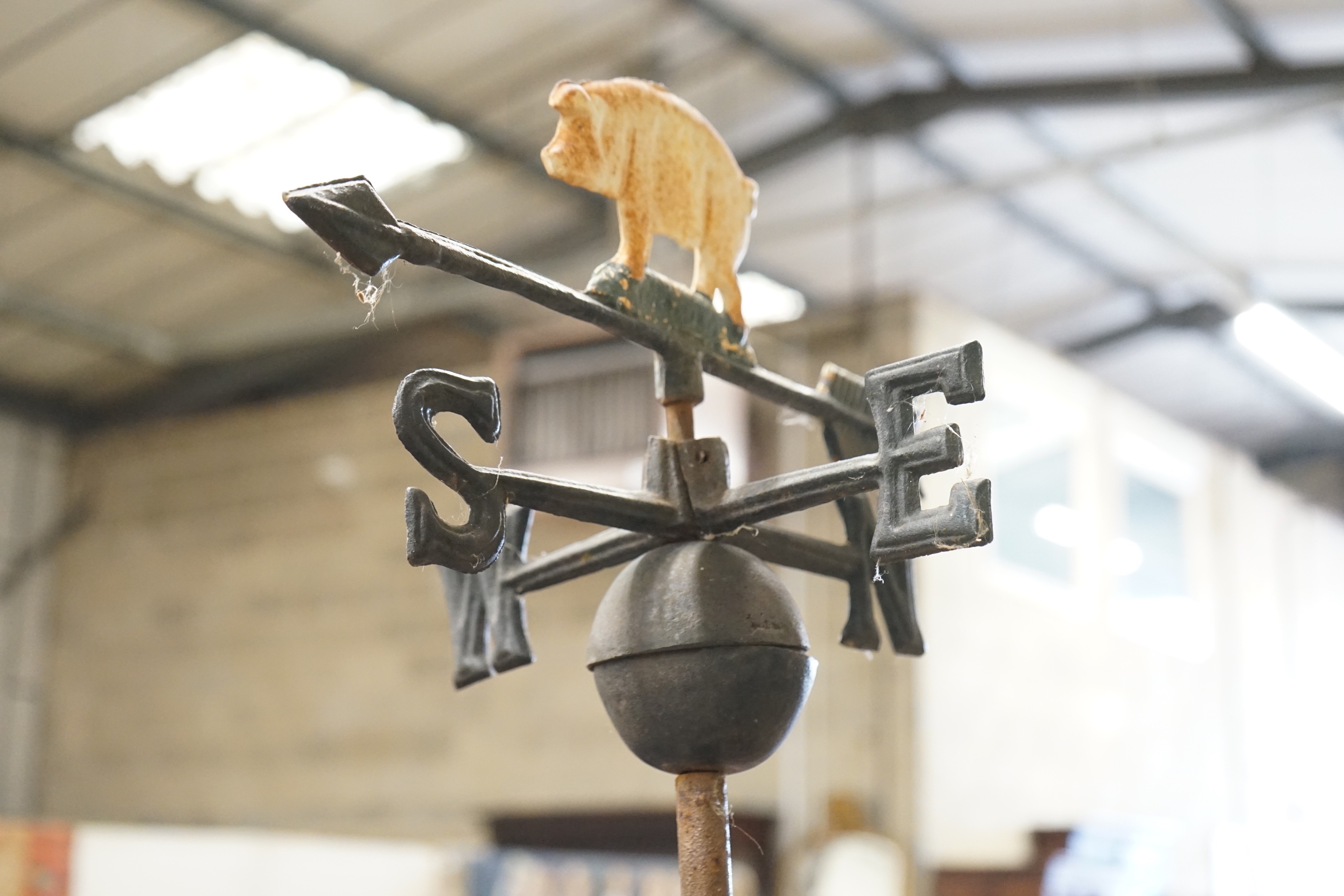 A painted metal pig weather vane on associated stand, height 76cm